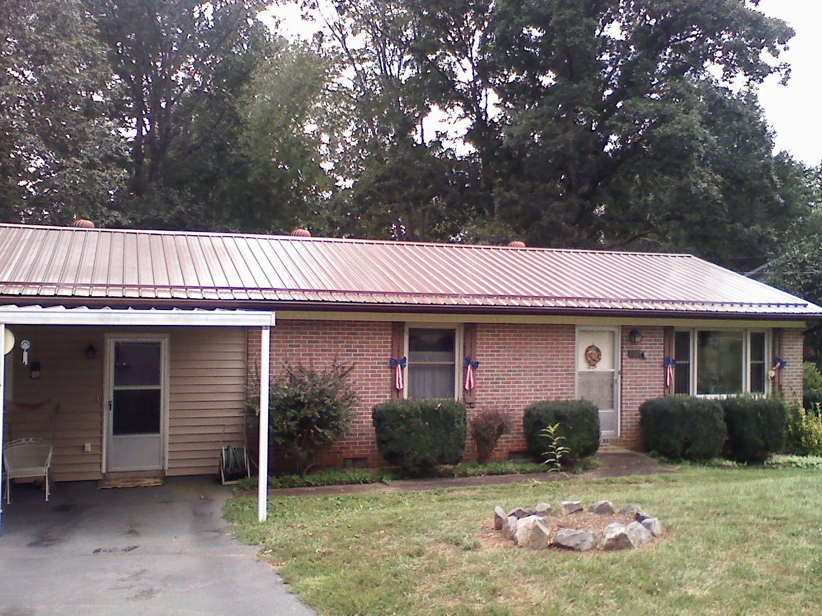 Bronze metal roof and carport on a brick ranch home — Roof Repair work by our crew in Villa Park
