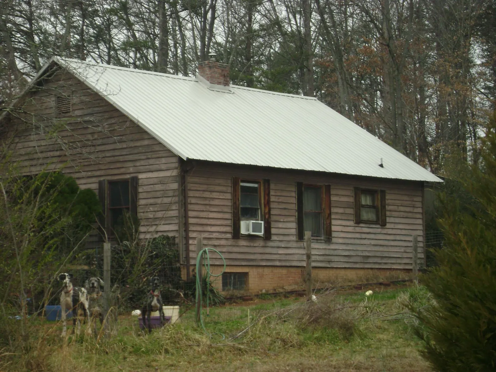 White metal roof on an old wood sided farmhouse, from a Metal Roof Installation job in Villa Park